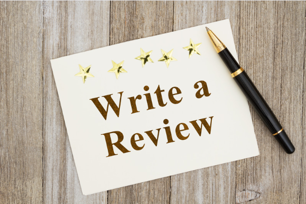 Image showing a note with the text "Write a Review" and five gold stars, emphasizing the importance of leaving airbnb guests reviews.