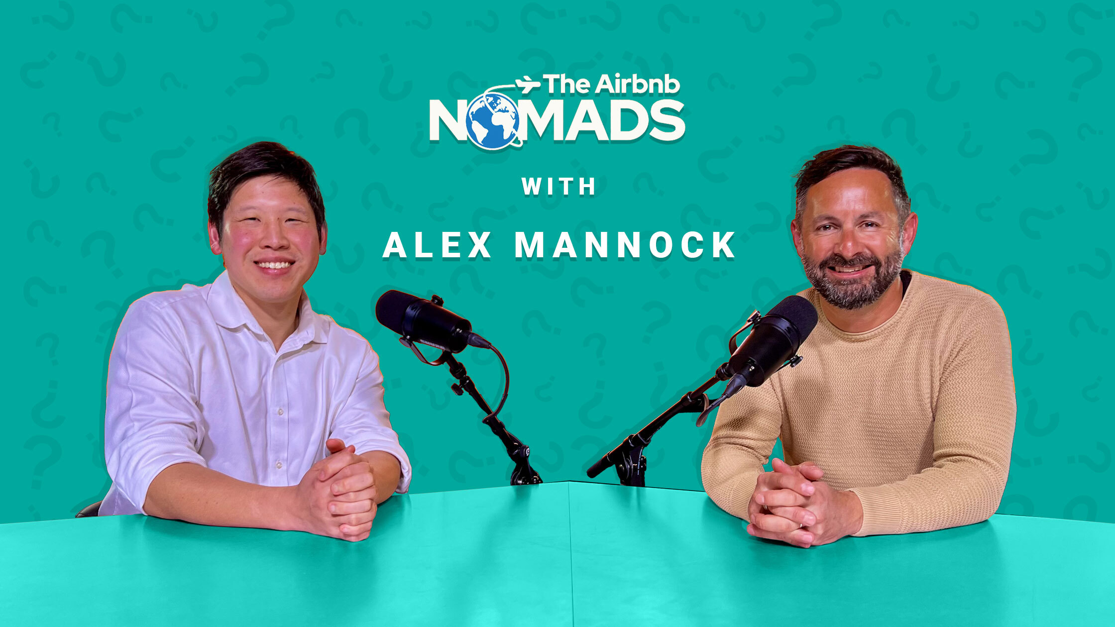 Alex Mannock and co-host sitting at a table with microphones, recording an episode of The Airbnb Nomads Podcast.